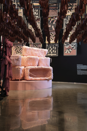 Art installations with pink bath tubs, knitted salami sausages and red rubber gloves.